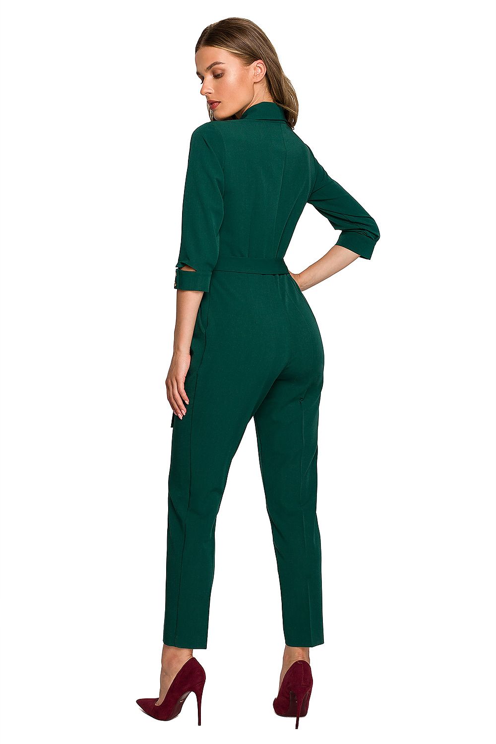 Back view of a luxurious green jumpsuit by Stylove, showcasing the elegant shawl collar and a defining waist tie for a sophisticated silhouette.