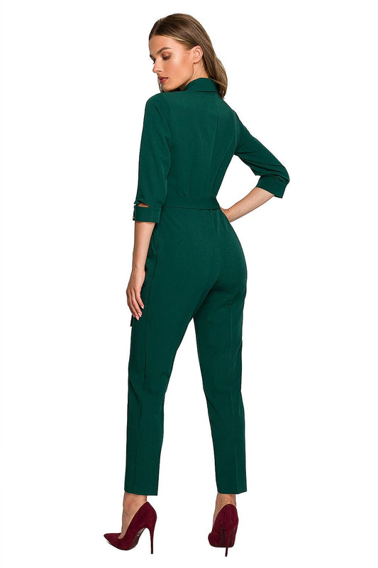 Back view of a luxurious green jumpsuit by Stylove, showcasing the elegant shawl collar and a defining waist tie for a sophisticated silhouette.