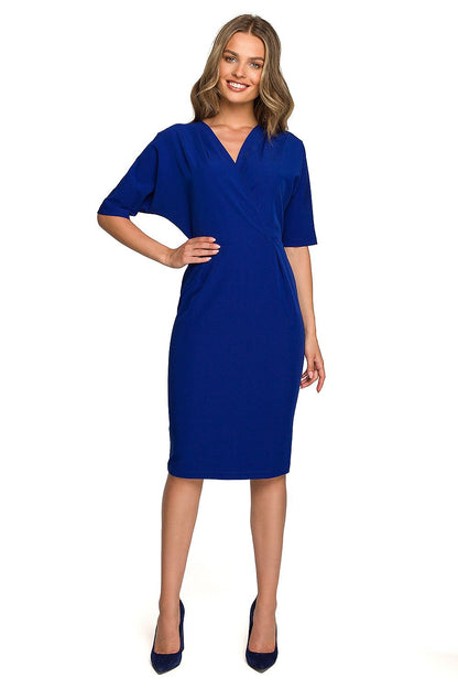 Sophisticated woman in a deep blue Stylove Daydress with batwing sleeves and a pencil cut, radiating luxury and style.