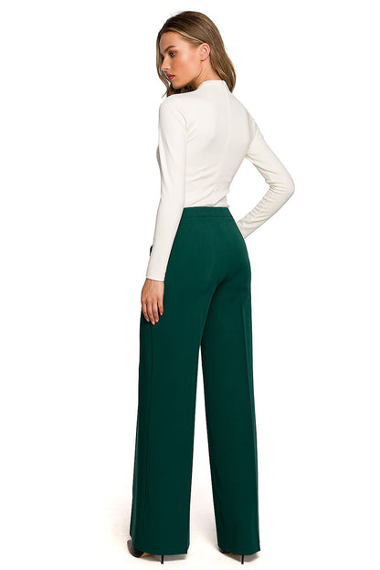 Back view of Stylove women's wide cropped trousers featuring a low-fitting waist, accentuating feminine curves against a crisp white top.