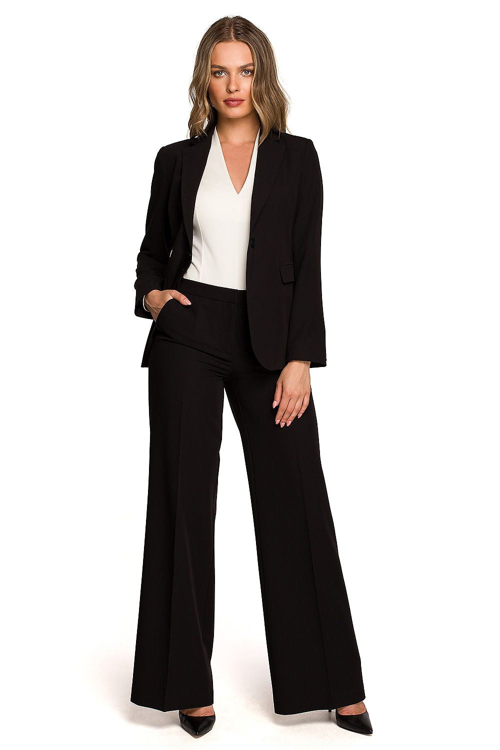 Stylish woman presenting a tailored black one-button waist jacket, paired with wide-leg trousers, ideal for professional settings.