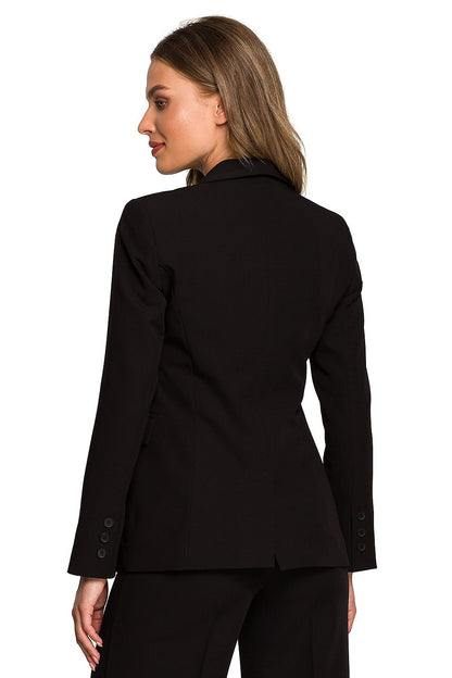 Detailed view of a woman in a black one-button waist jacket, showcasing a refined back design, essential for a polished look.