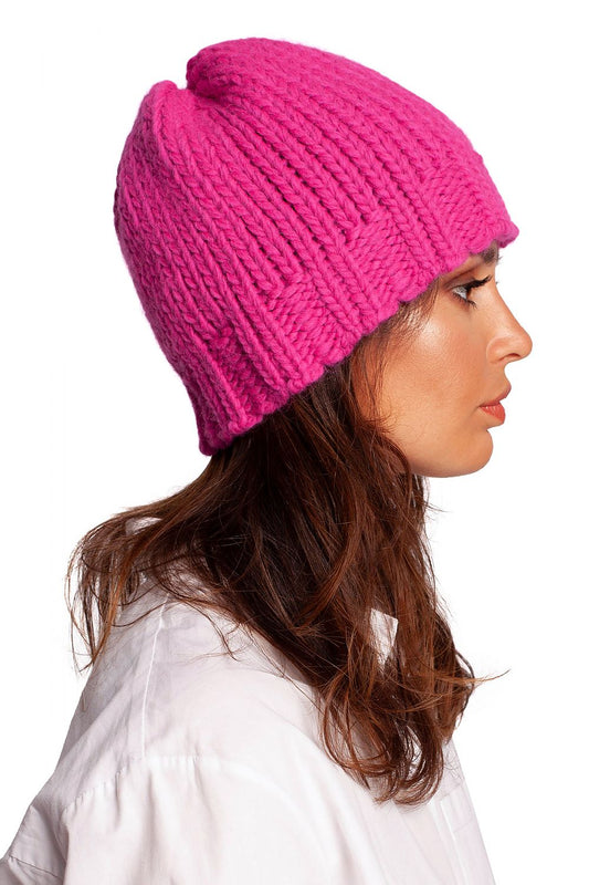 Side view of a luxurious pink thick-weave beanie cap, showcasing its ribbed design and chic style.