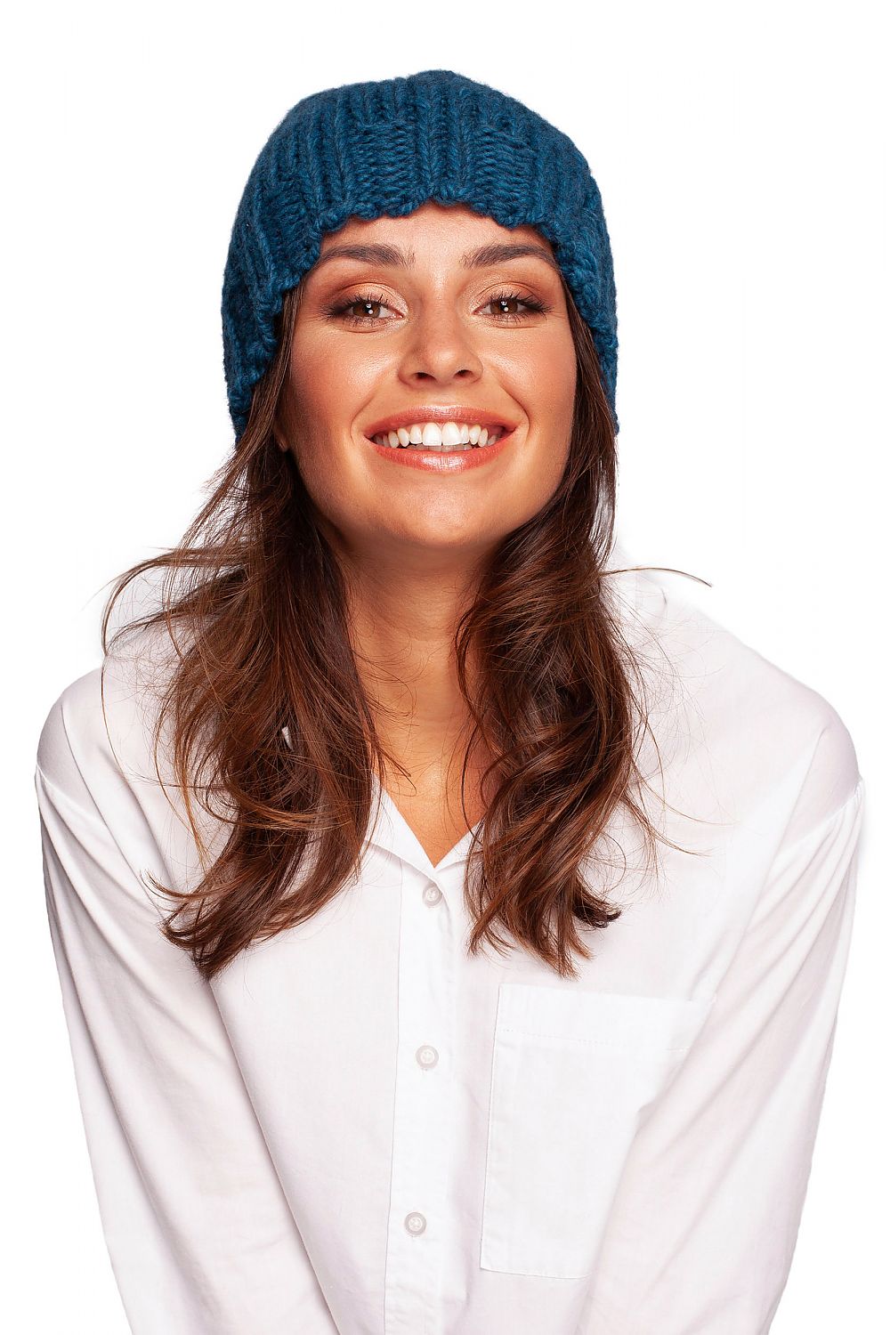 Charming model smiling while wearing a luxurious blue thick-weave beanie cap, perfect for cold weather.