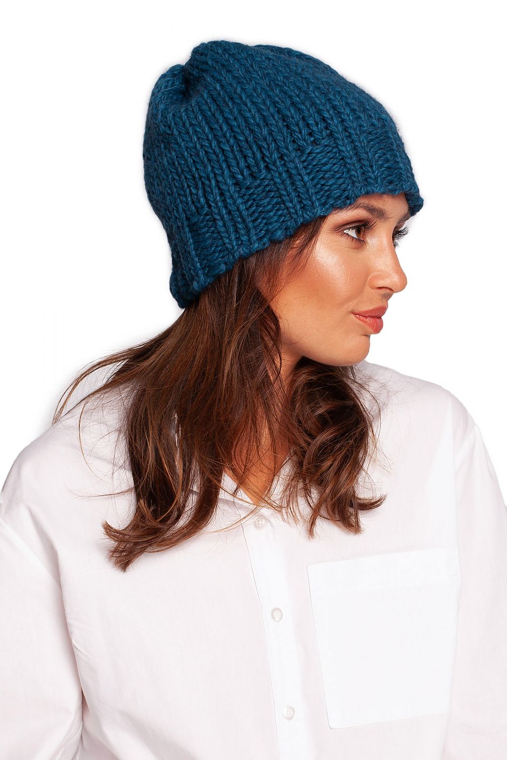 Side profile of an elegant blue thick-weave beanie cap, highlighting its fashionable ribbed texture for winter wear.