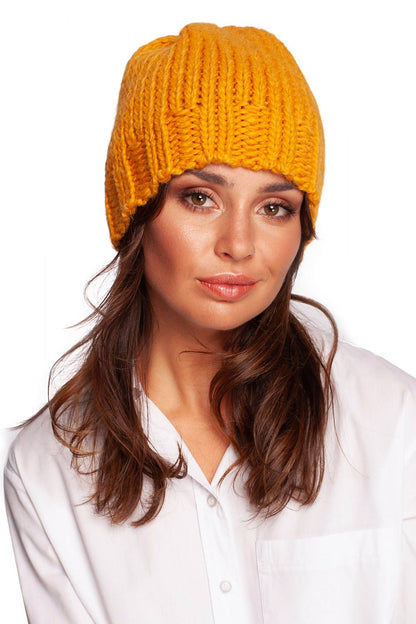 Luxury warm thick-weave beanie cap in vibrant yellow, featuring a stylish ribbed brim, modelled elegantly against a white backdrop.