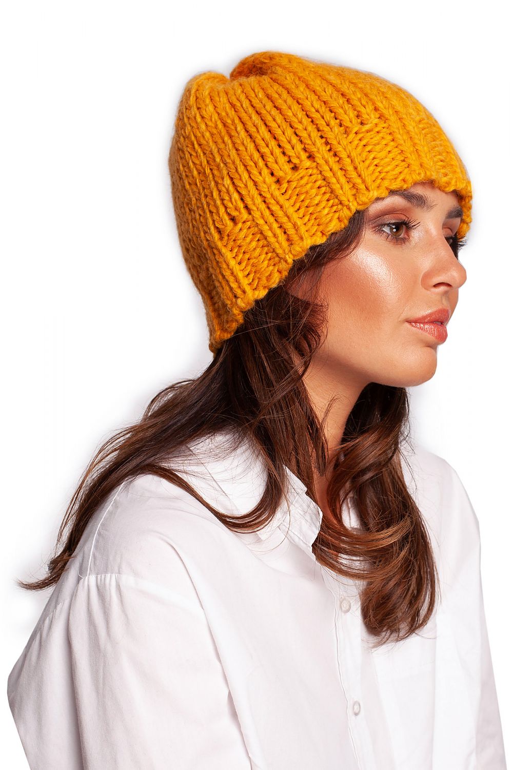 Side view of a luxurious yellow thick-weave beanie cap with ribbed brim, exuding winter charm, showcased by a model in a white shirt.