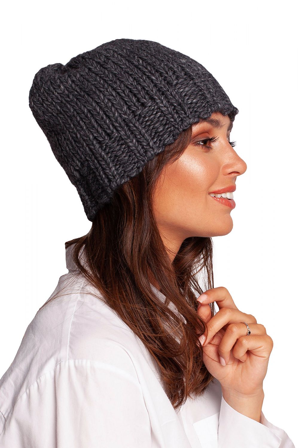 Side profile of a model showcasing an elegant grey thick-weave beanie cap, emphasizing warmth and sophistication against an uncluttered background.
