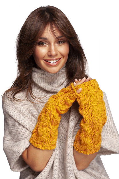 Elegant woman showcasing luxurious ribbed fingerless gloves in vibrant yellow, styled in cozy knitwear.