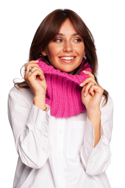 Chic model showcasing a vibrant pink infinity scarf, embodying cozy luxury for cold weather fashion.