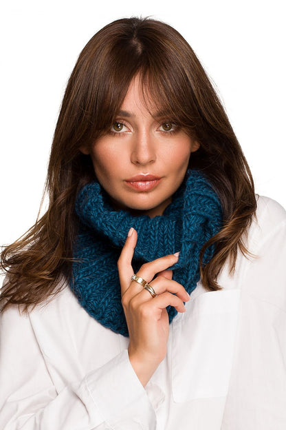 Sophisticated teal infinity scarf on a model, an ideal accessory for stylish warmth in colder seasons.