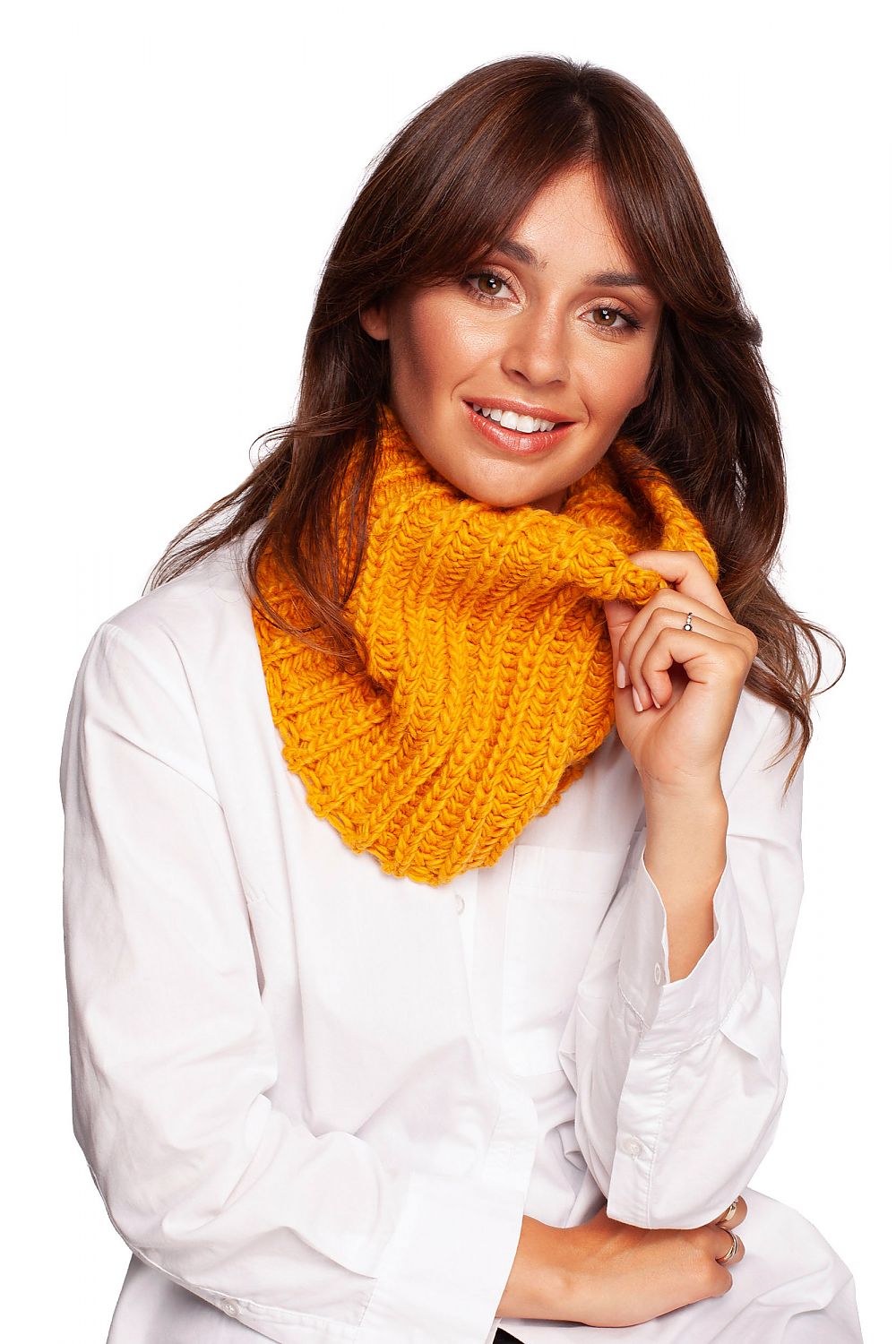 Glamorous model smiling while wearing a rich golden yellow infinity scarf, accentuating her chic autumn ensemble.