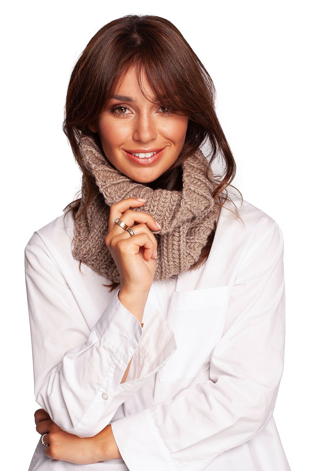 Fashionable woman beaming in a stylish beige infinity scarf, perfect for effortless warmth and elegance in autumn.