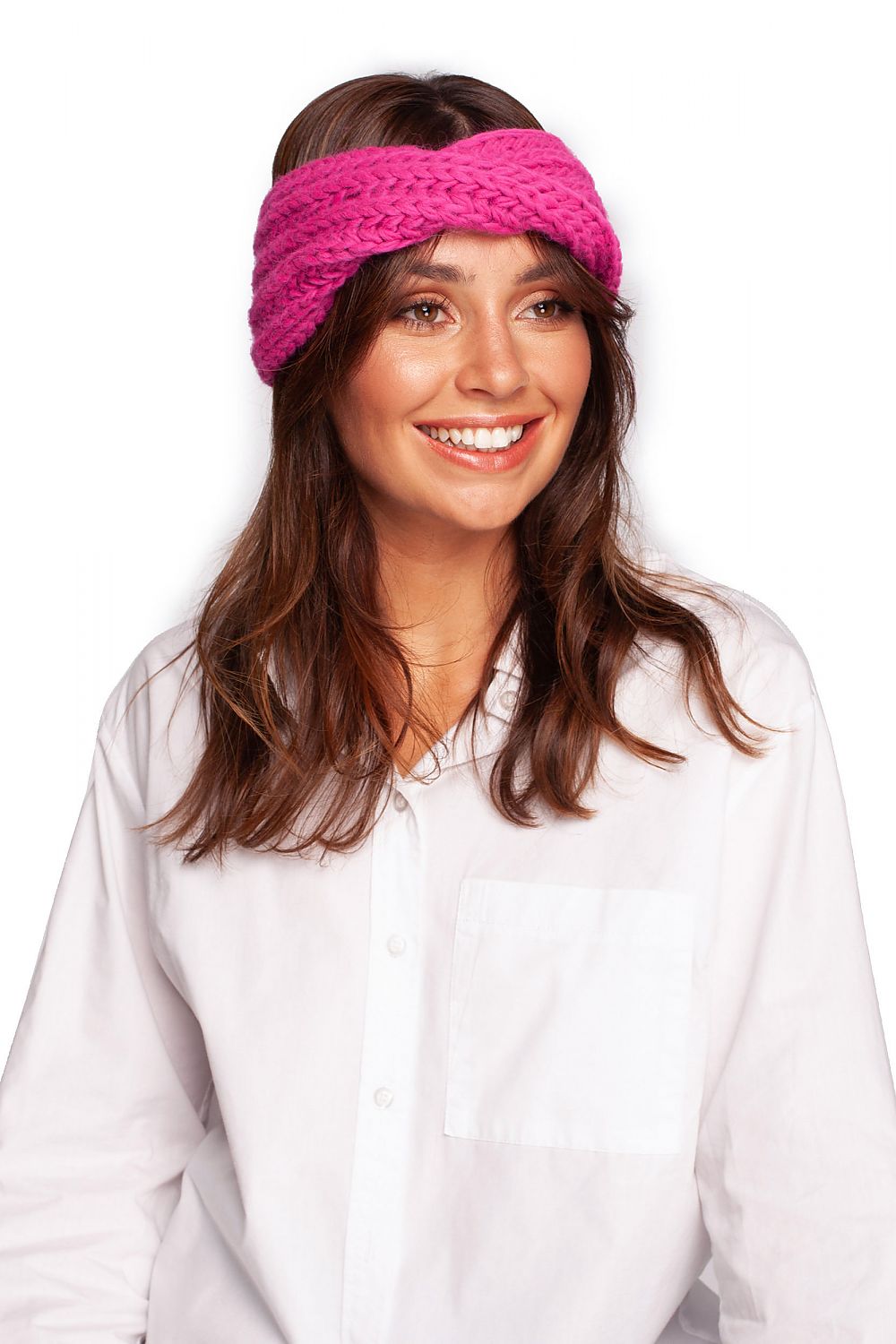 Luxurious pink knitted headband by BE Knit, showcased on a smiling model wearing a white blouse, perfect for stylish winter warmth.