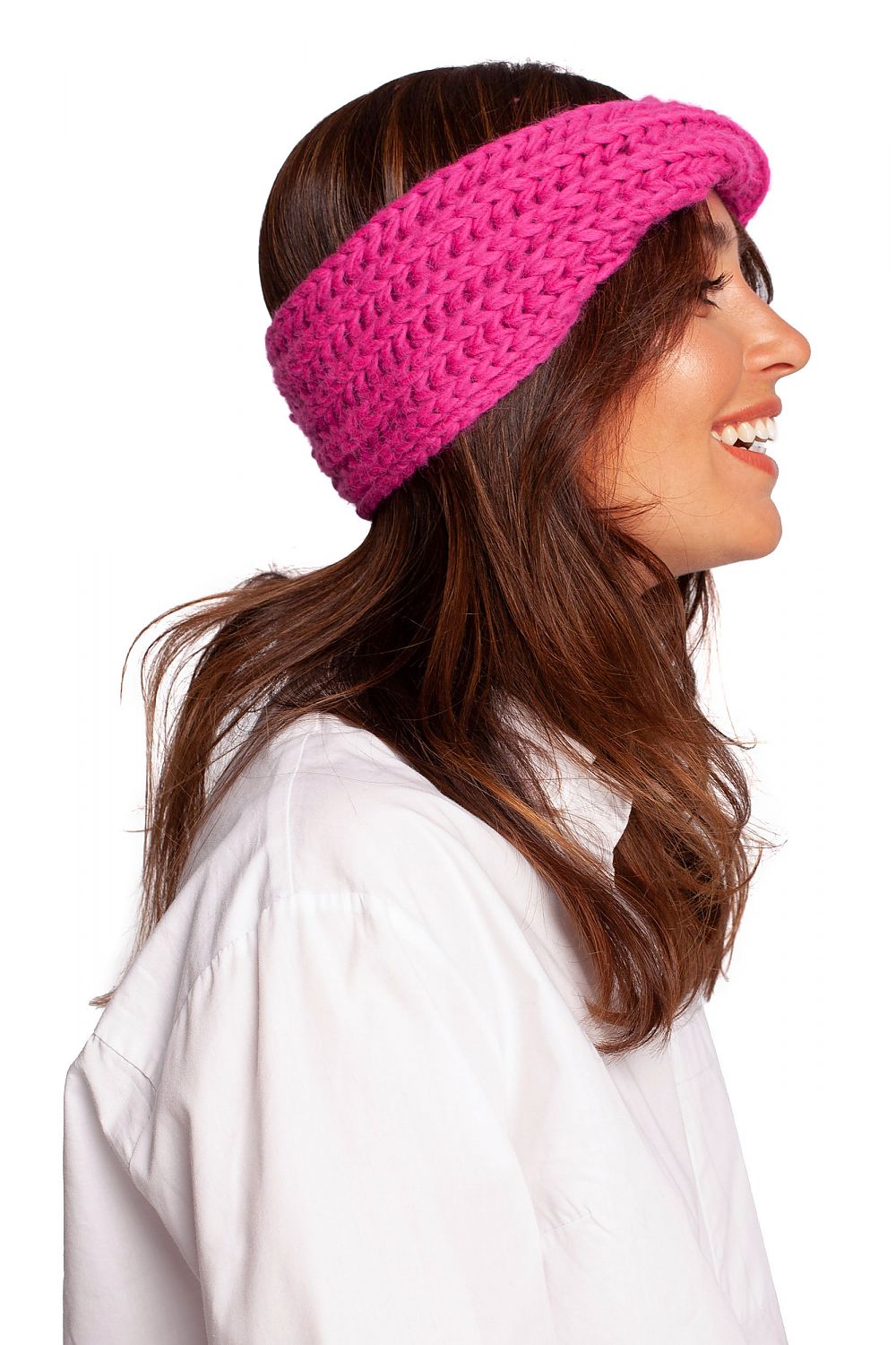 Side profile of a stylish pink headband by BE Knit, displayed on a model with long hair, suitable for chic winter fashion.