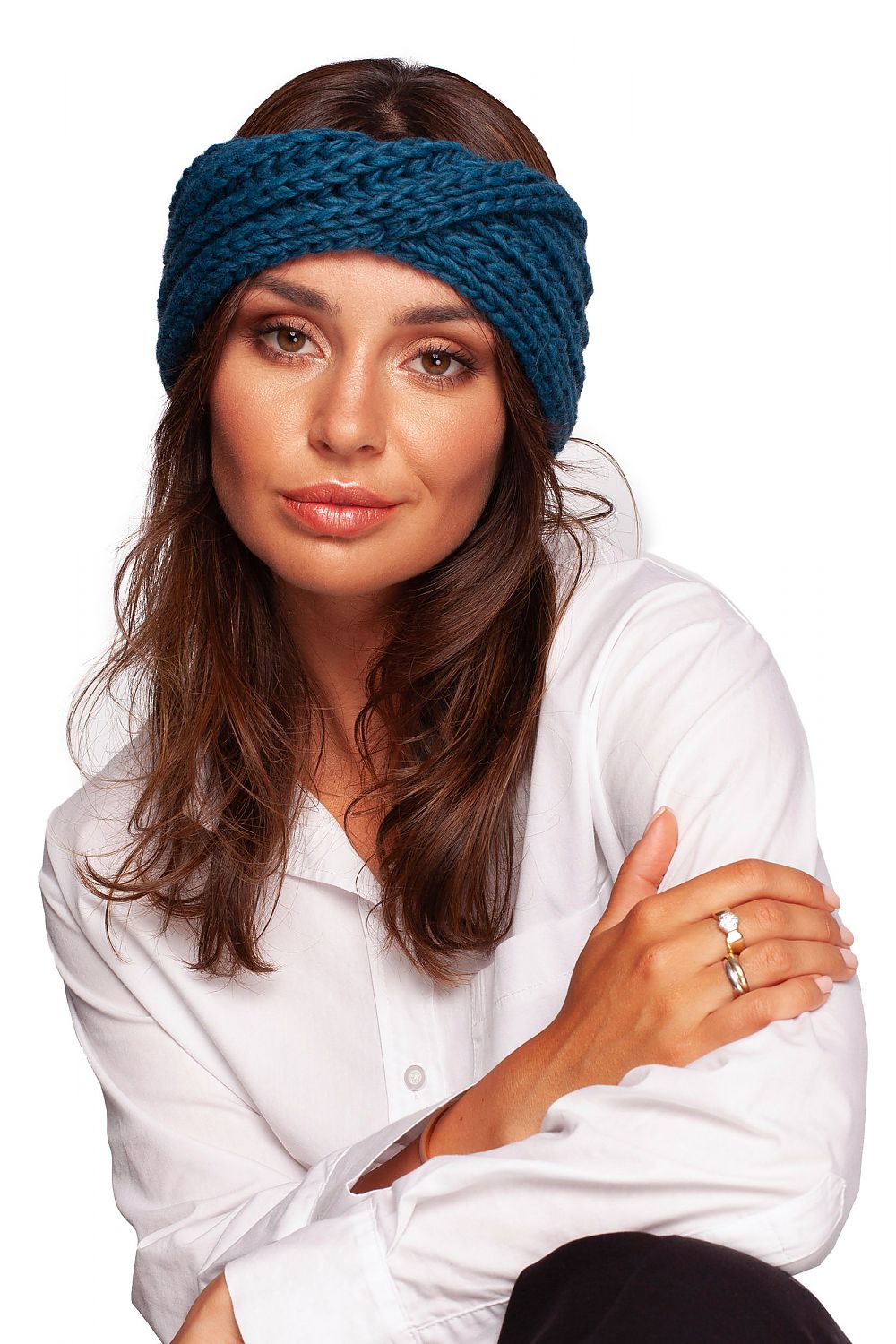 Elegant teal knitted headband by BE Knit, worn by a model with long hair, providing a fashionable touch for cold weather.