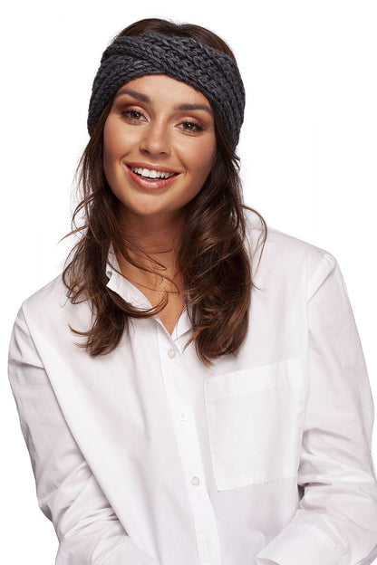 Smiling woman adorned with a luxurious grey headband by BE Knit, highlighting her elegant look while providing warmth and fashion for winter.