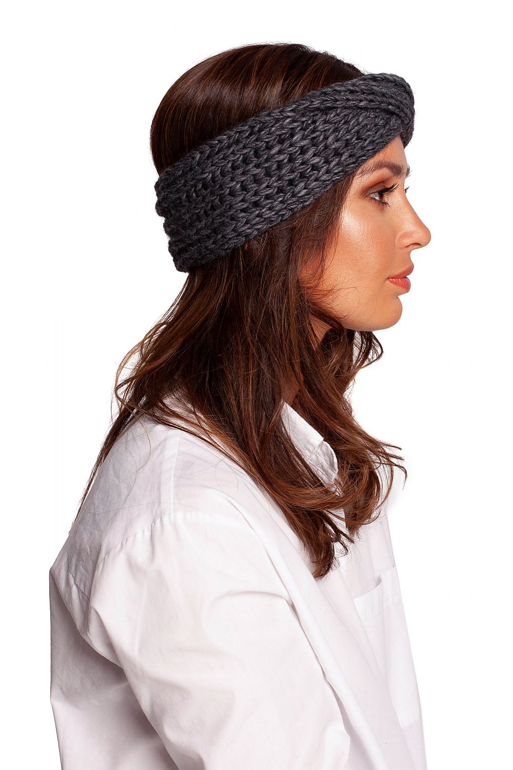 Profile view of a fashionable woman wearing a chic grey headband by BE Knit, combining warmth with trendsetting design for winter style.