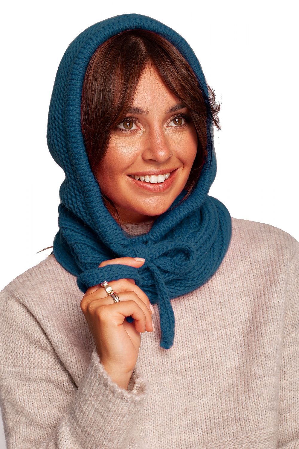 Elegant woman showcasing a luxurious infinity scarf in teal, designed in a warm acrylic, nylon, and wool blend, perfect for autumn fashion.
