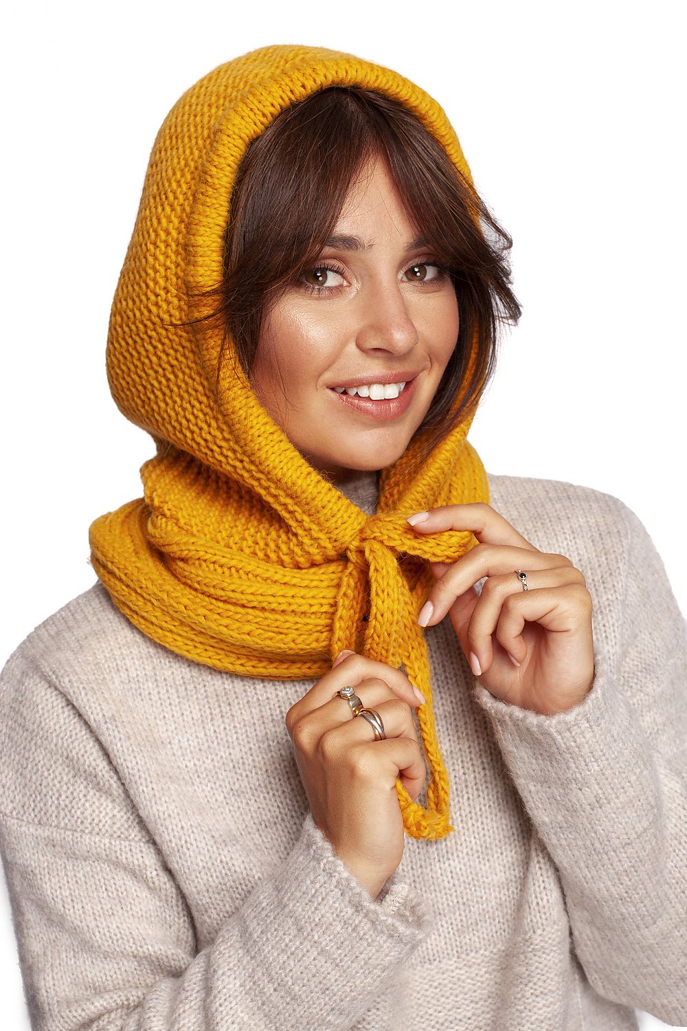 Luxurious yellow infinity scarf styled elegantly on a model, showcasing a warm knitted design, perfect for autumn fashion and sophistication.