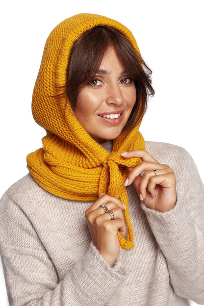 Luxurious yellow infinity scarf styled elegantly on a model, showcasing a warm knitted design, perfect for autumn fashion and sophistication.