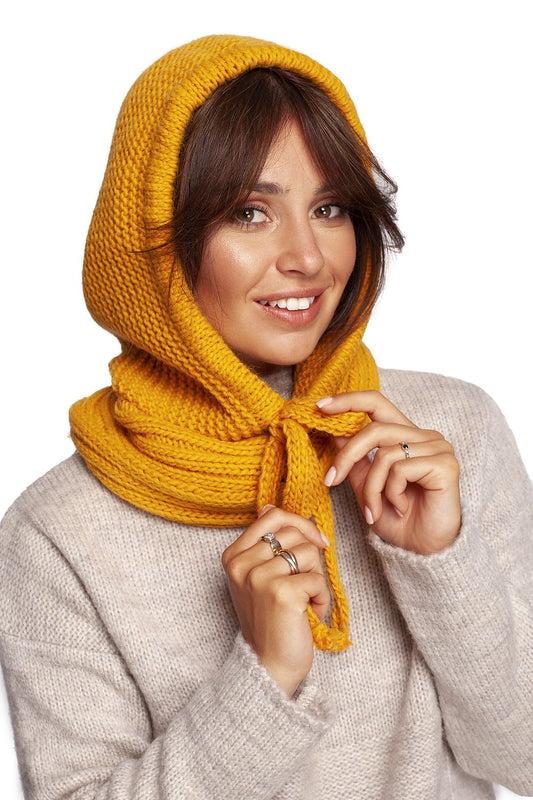 Luxurious yellow infinity scarf styled elegantly on a model, showcasing a warm knitted design, perfect for autumn fashion and sophistication.