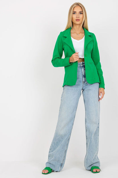 Elegant model showcasing a luxurious long sleeve green jacket by Och Bella, paired with light blue jeans and stylish green sandals. Perfect for sophisticated casual occasions.