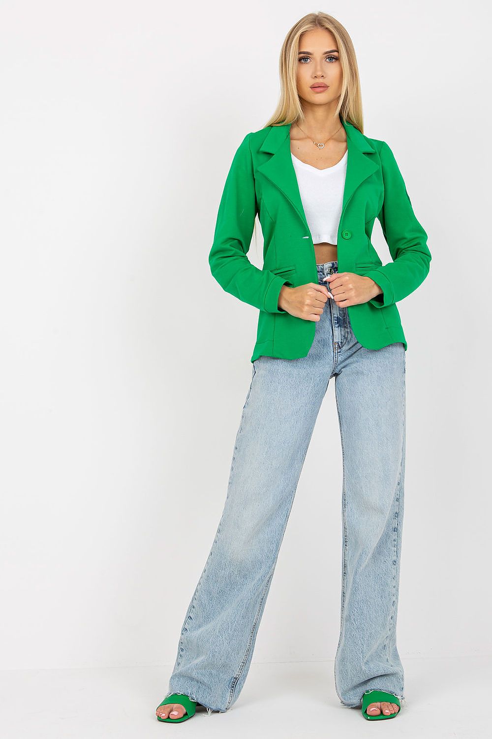 Chic perspective of a stunning green jacket with long sleeves by Och Bella, worn by a fashionable model. The ensemble features a white cropped top and flared denim trousers.