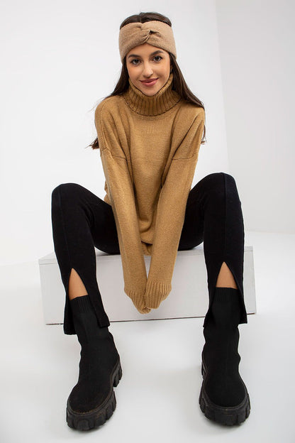 Luxurious women's turtleneck sweater, elegantly draped, paired with stylish black split leggings and trendy ankle boots, showcasing a perfect blend of comfort and high-fashion.