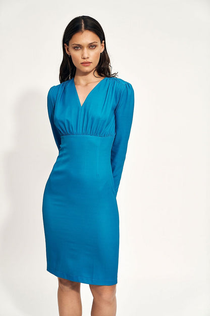 Chic fitted cocktail dress in vibrant teal, featuring a stylish v-neckline and long sleeves, embodying elegance for formal events.