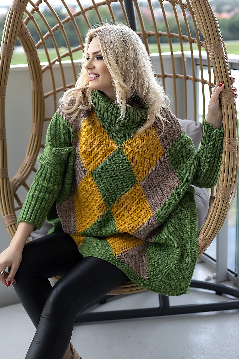 Fashionable women's turtleneck poncho sweater featuring bold colours in a striking diamond pattern. Designed for comfort and elegance, perfect for a luxurious casual ensemble.