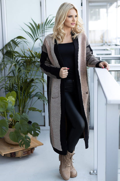 Luxurious long sleeve cardigan fashioned from soft fluffy fabric by PeeKaBoo, showcased in an elegant indoor setting, featuring neutral tones and pockets, paired with chic black leggings and stylish beige boots.