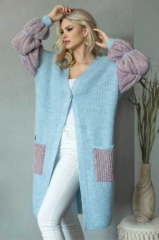 Luxurious long sleeve cardigan in soft blue wool blend with stylish puffed sleeves, featuring a single button closure and practical side pockets, elegantly showcased against a minimalist backdrop.
