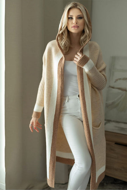 Elegant luxury loose cardigan with hood in soft fluffy fabric, featuring slip pockets, worn by a model against a stylish interior backdrop.