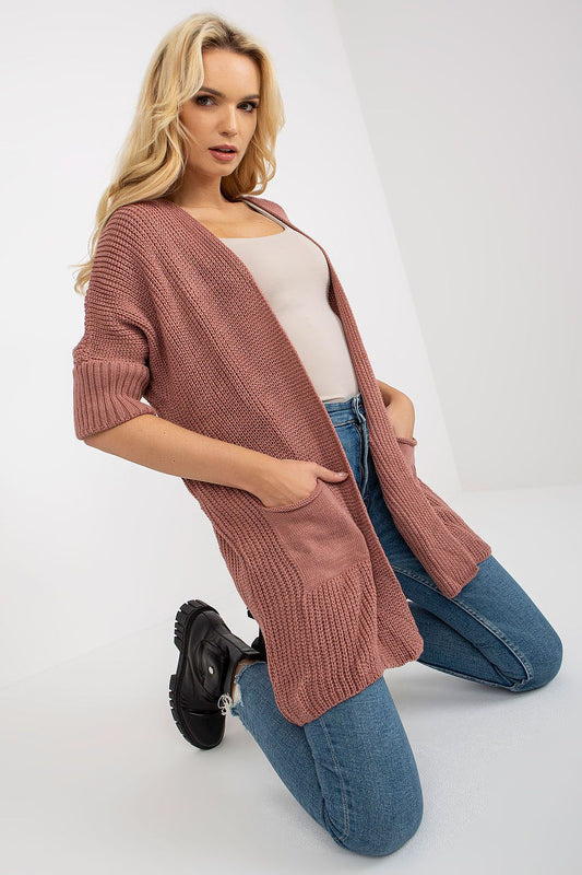 Luxury unbuttoned cardigan with 3/4 sleeves, featuring slip pockets, styled in a warm pink tone for a chic look.