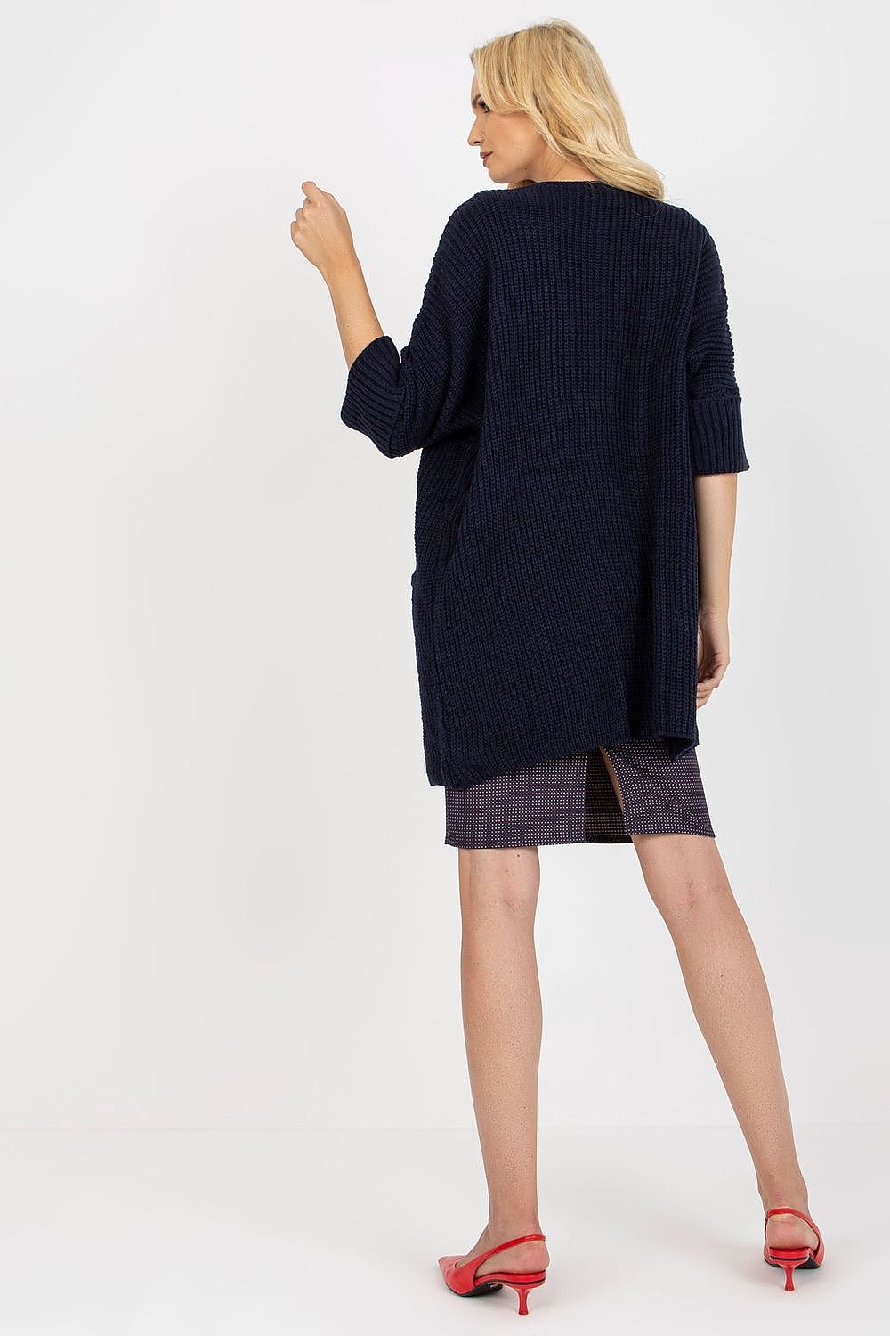 Back view of the exquisite navy blue unbuttoned cardigan, revealing its relaxed fit and luxury texture, harmoniously styled with a fashionable skirt.