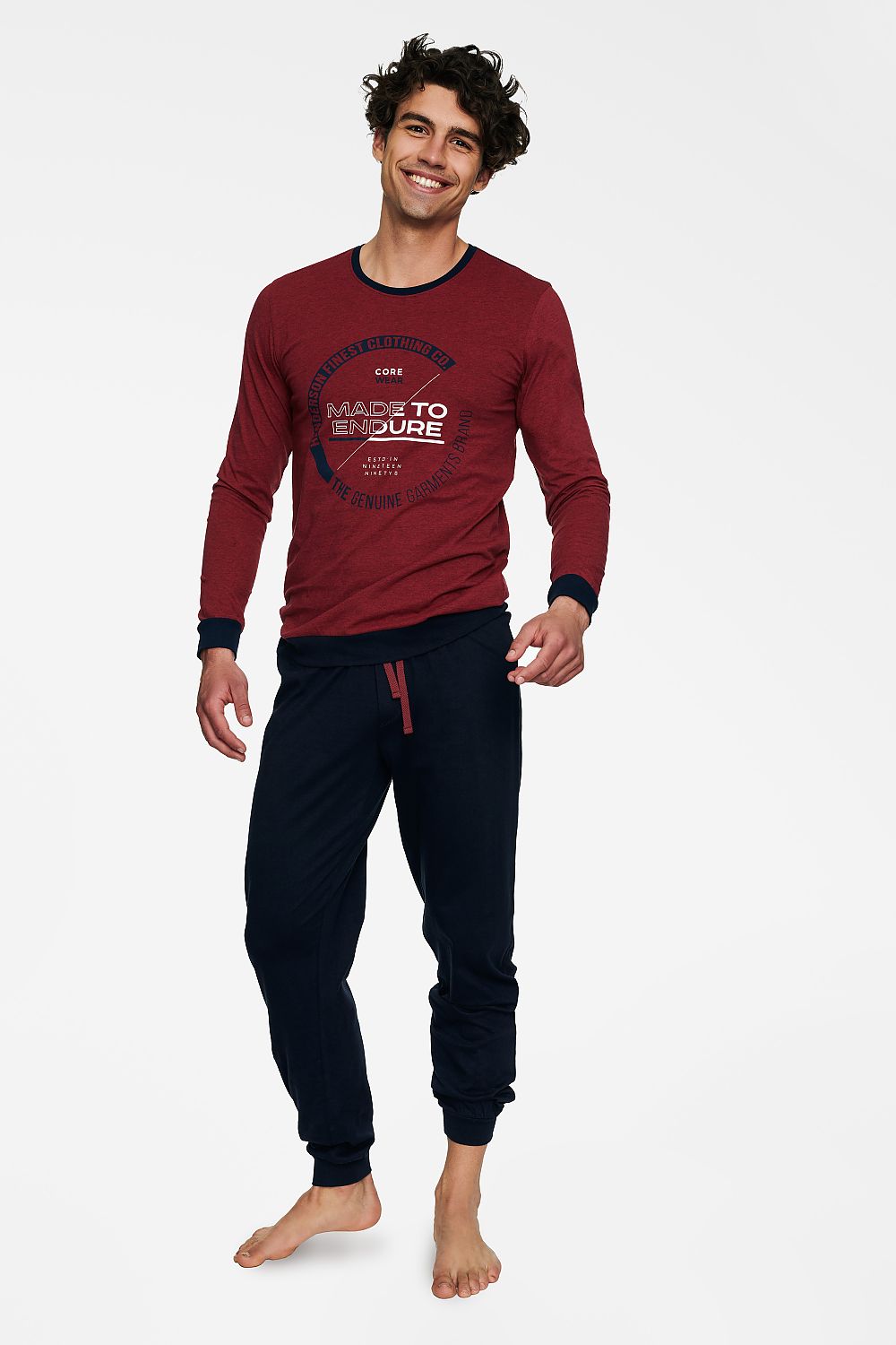 Elegant men’s cotton two-piece pyjamas set featuring a soft long-sleeve T-shirt adorned with a stylish graphic and comfortable long pants, designed for a luxurious loungewear experience.