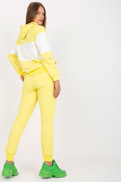Chic rear view of a woman dressed in a luxurious yellow cotton blend hoodie and sweatpants set, highlighting the stylish design and comfortable fit.