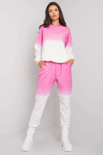 Chic women's lounge set featuring an ombre pink and white sweatshirt paired with elastic waist pants, perfect for lounging in luxury.