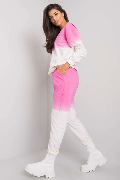 Stylish side view of an elegant women's ombre lounge set in pink and white, showcasing the comfortable sweatshirt and matching pants with pockets.