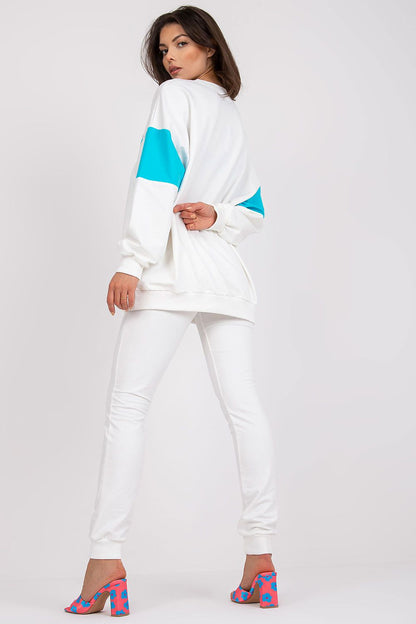 Fashionable women's tracksuit set displaying a white sweatshirt with aqua highlights and tailored pants, designed for a modern and luxurious athleisure look.
