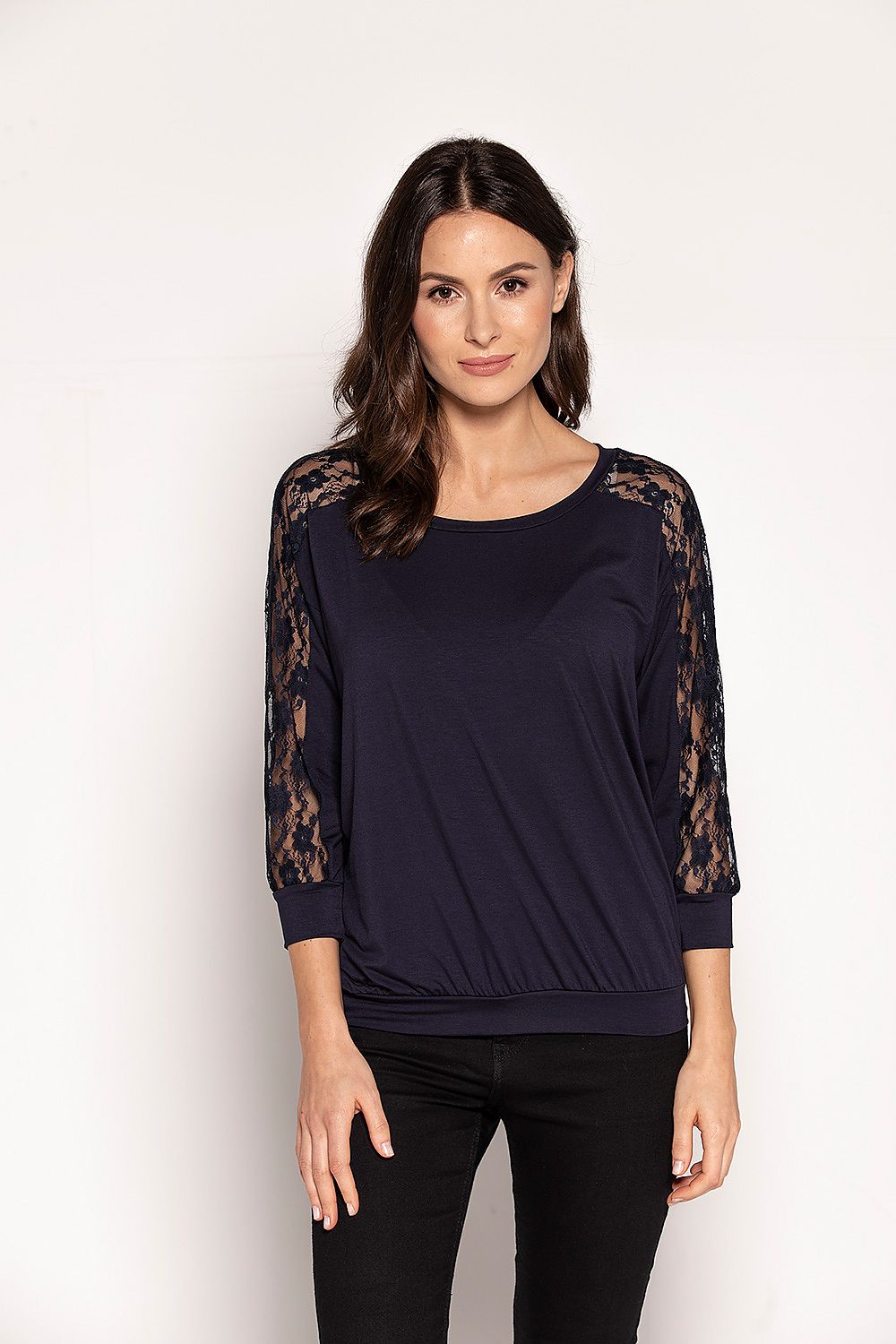 Elegant navy blue blouse by Babell featuring lace detailing along the sleeves, designed for a sophisticated look. Perfect for spring with a comfortable, slightly loose cut and 3/4 sleeves, highlighting the shoulders.