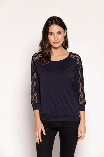 Elegant navy blue blouse by Babell featuring lace detailing along the sleeves, designed for a sophisticated look. Perfect for spring with a comfortable, slightly loose cut and 3/4 sleeves, highlighting the shoulders.
