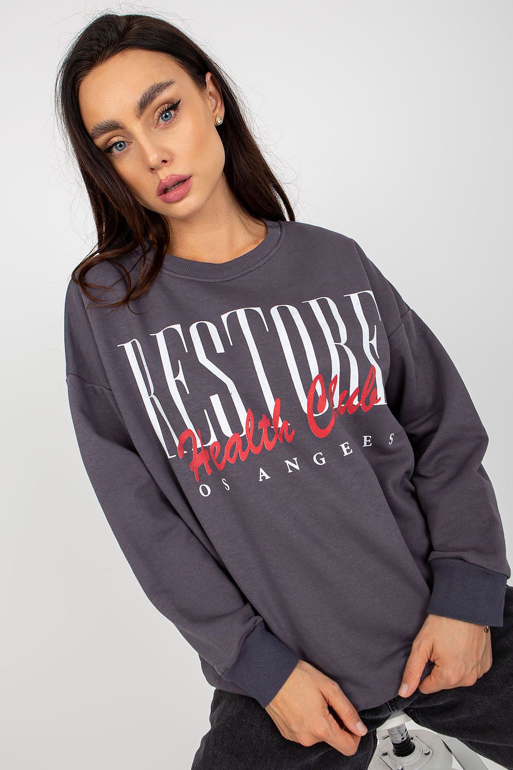 Luxurious long-sleeved cotton sweatshirt featuring a bold decorative print, styled elegantly with casual flair for modern sophistication.