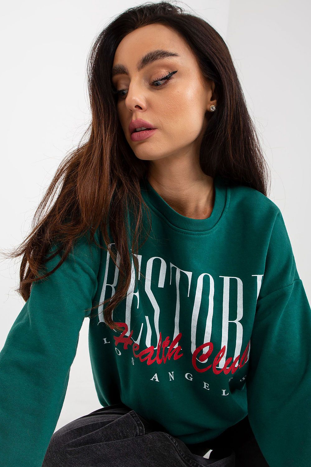 Close-up of a luxurious long-sleeved sweatshirt in green with a stylish print, showcasing soft cotton fabric and contemporary design, perfect for effortless elegance.