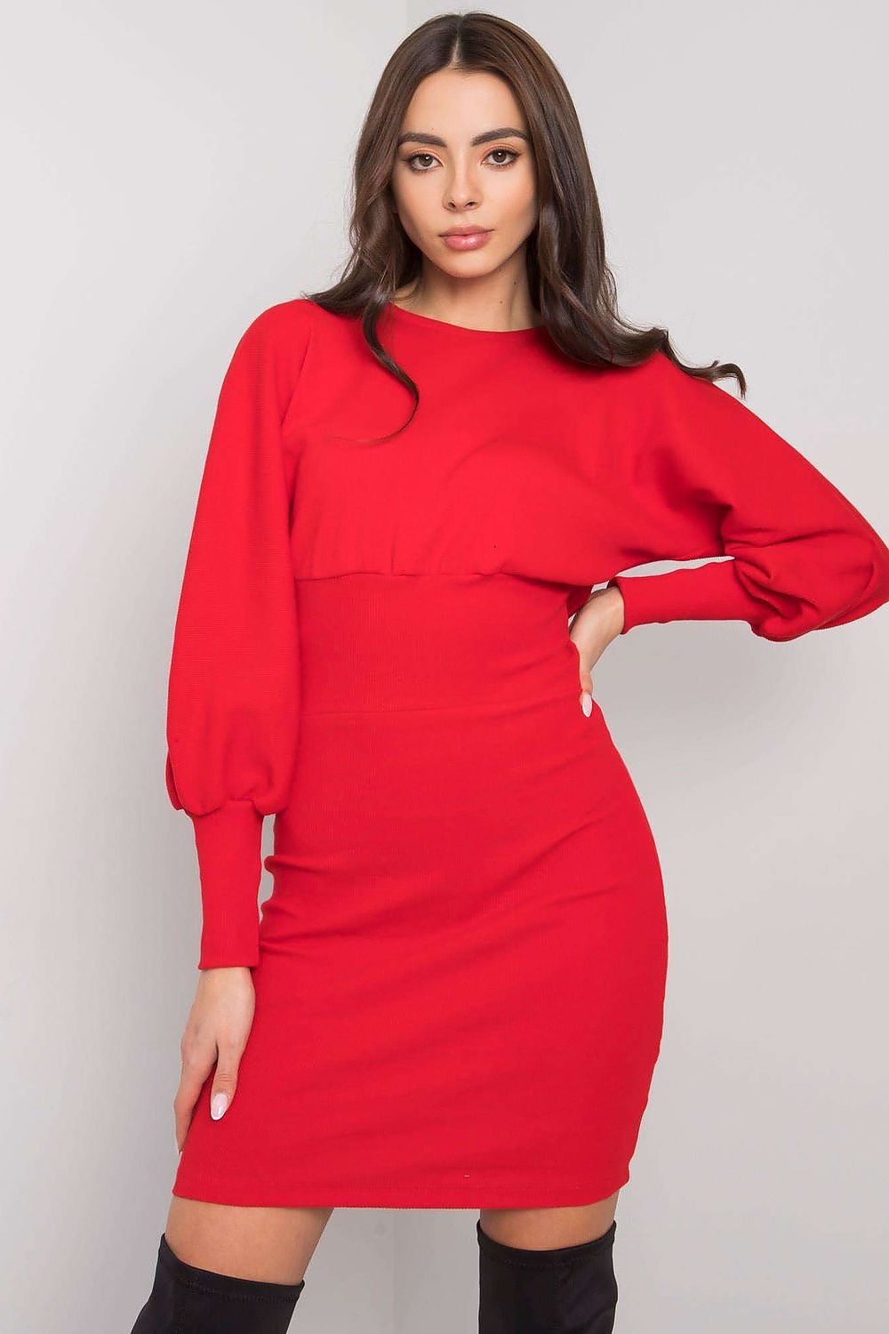 Chic woman wearing an elegant red fitted cotton and spandex daydress with long sleeves, showcasing sophistication and style against a minimalist background.