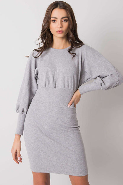 Refined light grey daydress by Rue Paris, featuring a figure-hugging cut and statement puffed sleeves, captured in an elegant pose.
