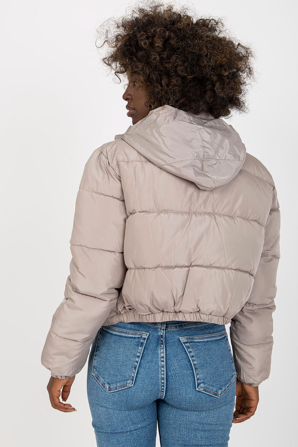 Stylish back view of a luxurious quilted jacket in a soft beige tone, featuring a hood and gathered hem, ideal for chic winter outfits.