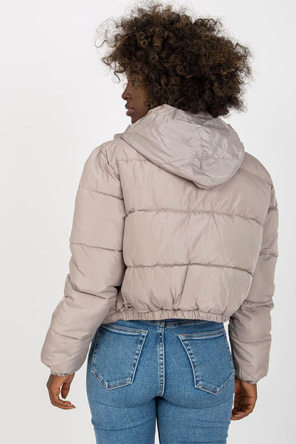 Stylish back view of a luxurious quilted jacket in a soft beige tone, featuring a hood and gathered hem, ideal for chic winter outfits.