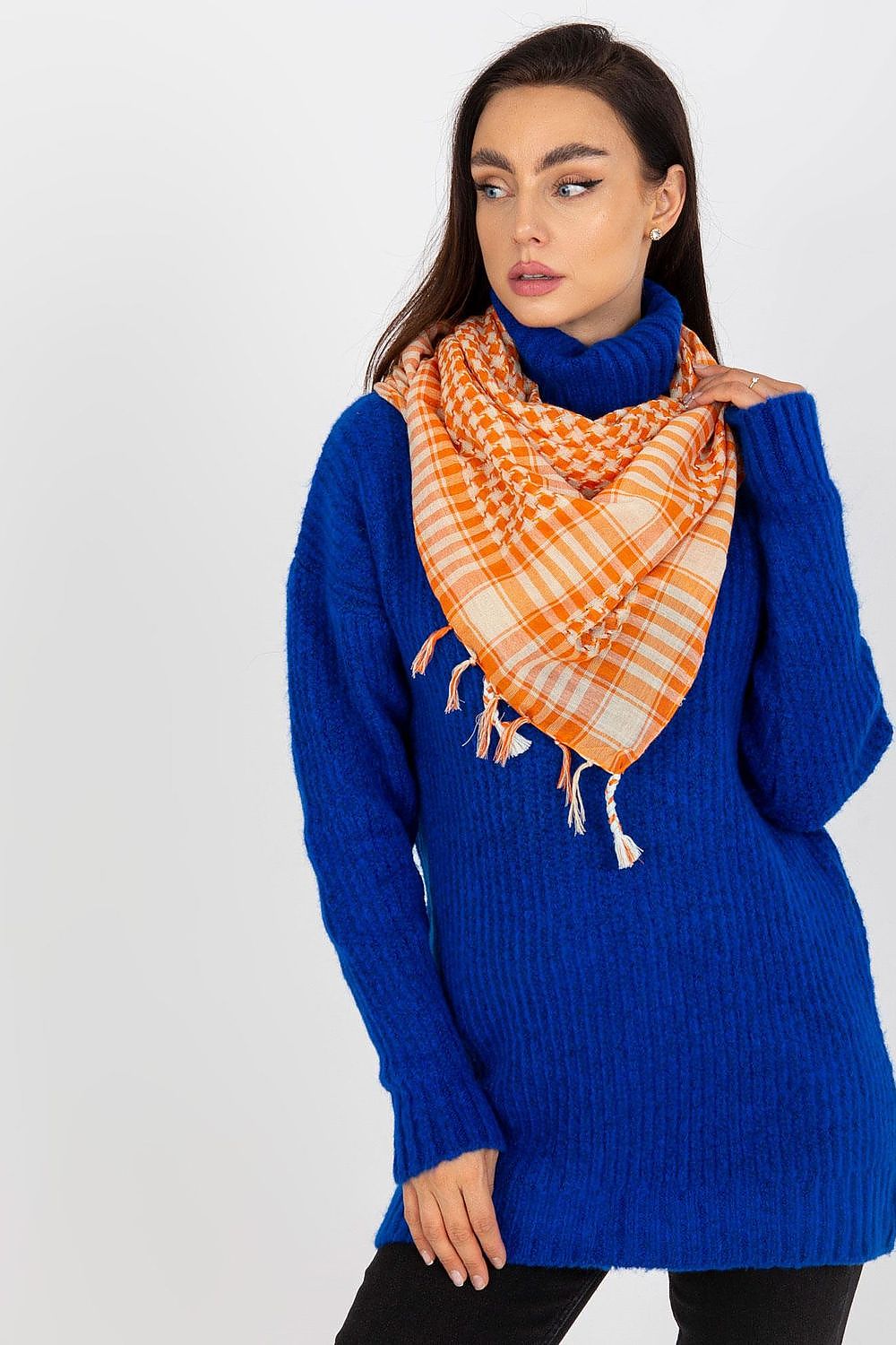 Chic orange and cream checkered neckerchief scarf draped gracefully around the model's neck, complementing a stylish blue oversized sweater for a trendy attire.